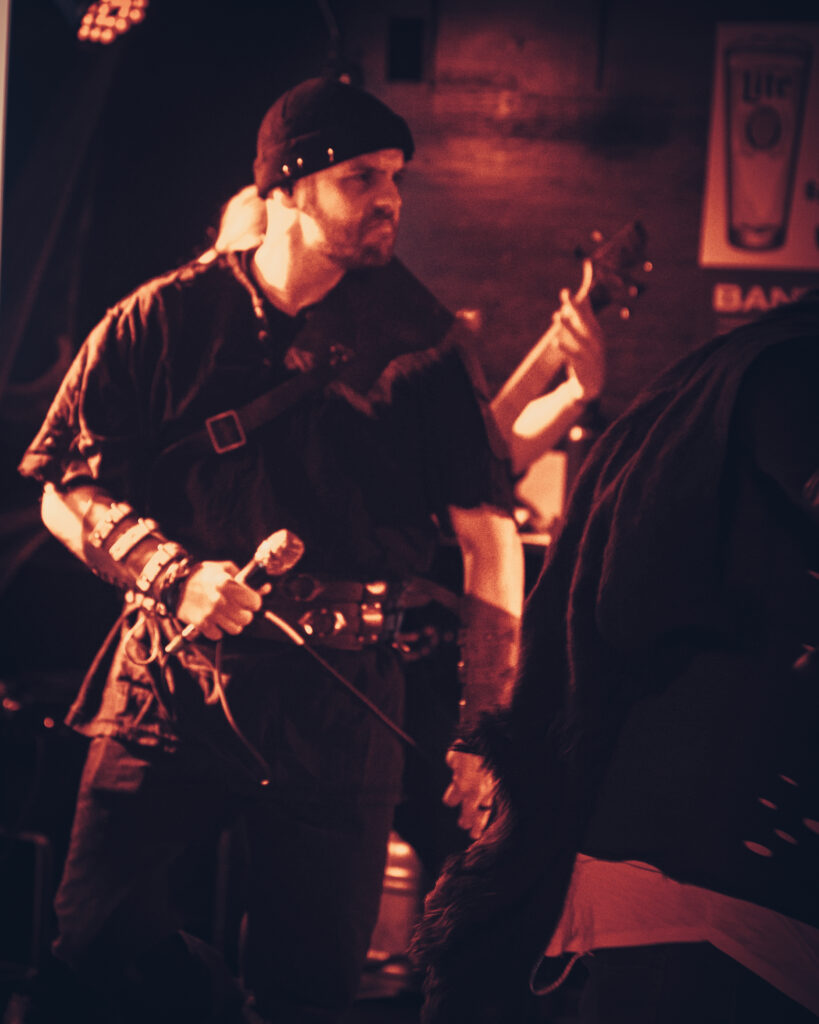 Gritty photograph of a vocalist staring down the crowd.