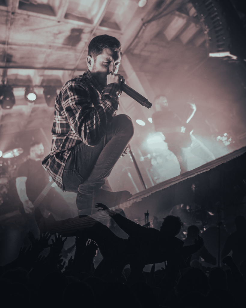 A collage of Phil Bozeman screaming above a crowd surfer at Empire Live in Albany, NY.